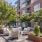 a spacious patio with lounge seats and lush landscaping