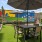an outdoor seating area with turf and umbrella seating
