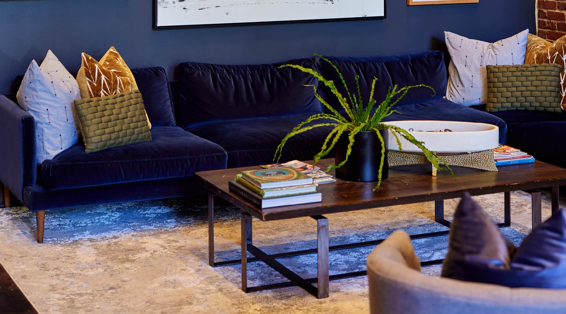 LUXURY APARTMENTS IN DURHAM, NC couch and gallery wall in clubhouse