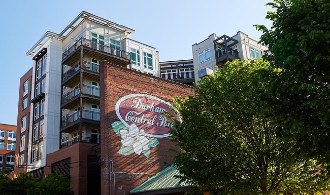 CULTURALLY CRAFTED brick wall with a painted sign for Durham Central Park